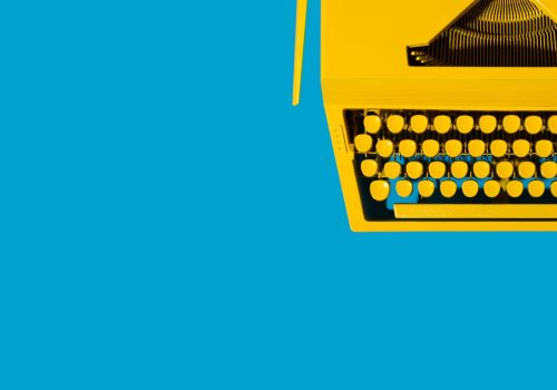yellow-typewriter-against-a-bright-blue-background-2026-01-07-06-14-10-utc