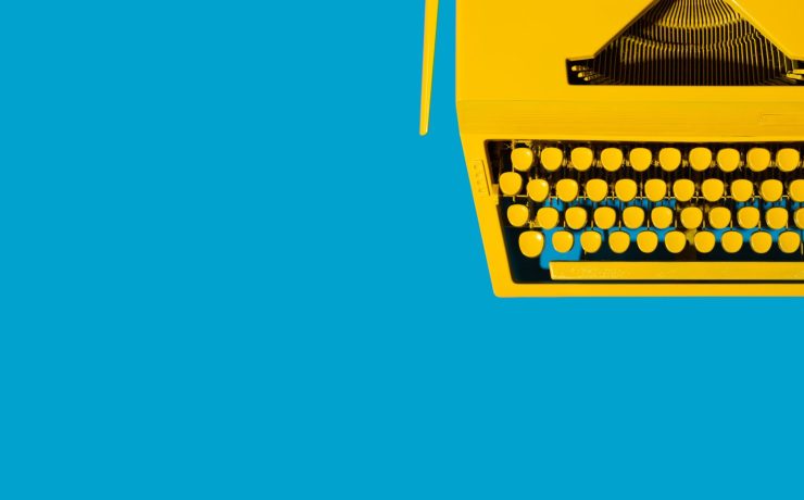 yellow-typewriter-against-a-bright-blue-background-2026-01-07-06-14-10-utc